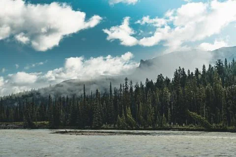 The Athabasca river flows by the Canadian rocky mountains in Alberta, Canada Stock Photos