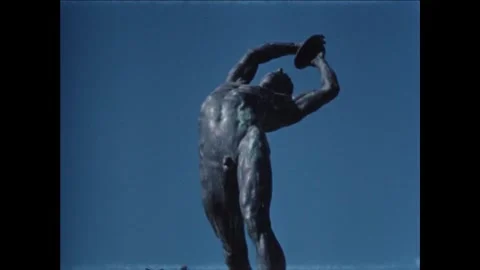 ATHENS - 1959 - A bronze statue of a discus thrower on display in front of the Stock Footage 308100768