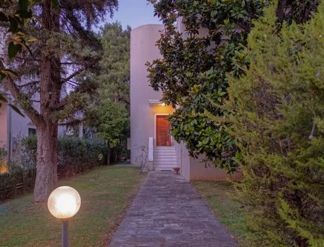Athens Greece, stone path through the garden to elegant house entrance, night Stock Photos