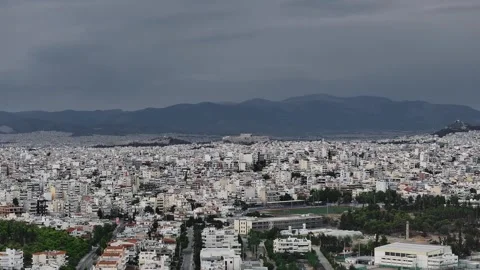 Athens urban sprawl with distant Acropolis landmark under stormy overcast sky Stock Footage 345372167
