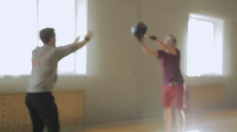 Athlet catches and throws heavy black ball to trainer and does burpee Video stock 64079358