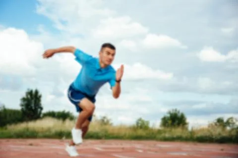 Athlet running fast at the stadium Stock Photos