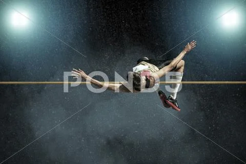 Athlete in action of high jump. Stock Photos