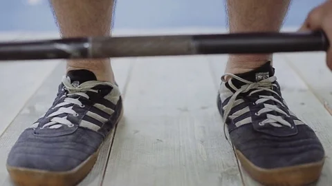 The athlete approaches the bar and prepares to lift the weight Stock Footage