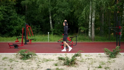 Athlete awlking and stretching before a work out on an outdoor training gro.. Stock Footage 341728993