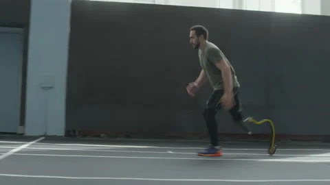 Athlete with Below Knee Prosthesis Running in Stadium Stock Footage 202013805
