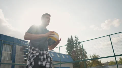 Athlete Bouncing Volleyball During Training in Outdoor Sports Arena Stock Footage 302377586