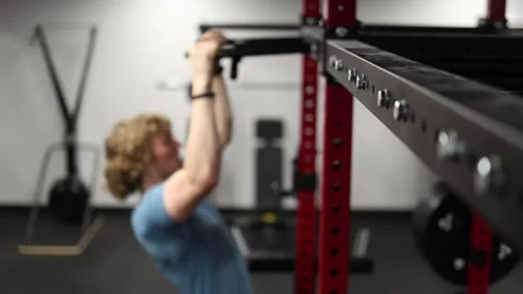 Athlete builds strength with controlled pull ups in the gym Video stock 339321577