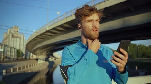 Athlete checking pulse after jogging Stock Footage 134451028