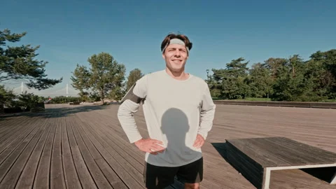 Athlete Checking Time, Highfiving with Girl and Jogging along Wooden Deck Stock Footage 318496882