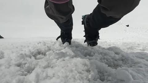 Athlete climber descends down a snowy slope. View down on the legs Stock-Footage 246292592