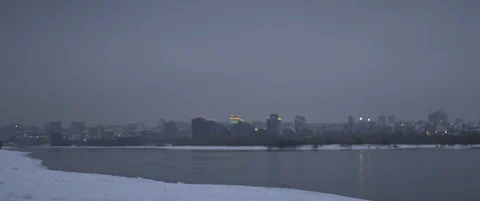 Athlete completes winter run in snow on river bank in dusk. Jogging, outdoor Stock Footage 120299172