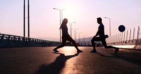 Athlete copuple leaping into the air in triumphant joy in beautiful natural s 스톡 동영상 67248949