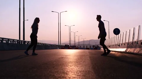 Athlete copuple leaping into the air in triumphant joy in beautiful natural s Stock-Footage 67355366