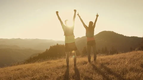 Athlete couple running and reaching top of the hill, moutain view - success Stock Footage