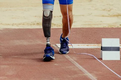 Athlete disability measures run-up in long jump at athletics competition Stock Photos