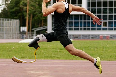Athlete disability runner running sprint race in athletics Stock Photos