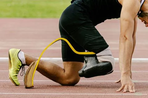 Athlete disability runner starting position in running sprint race Stock Photos