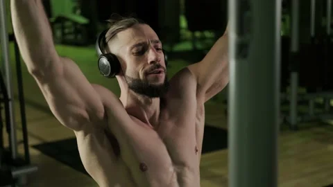 A athlete does a back exercise with the help of a sport equipment Video stock 234629765