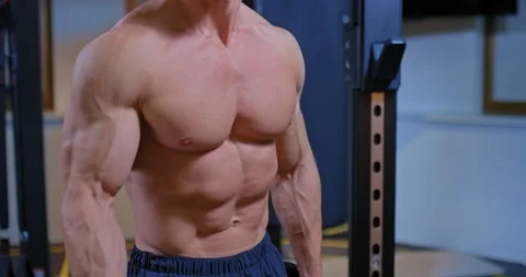 Athlete does a basic exercise for the muscles of the arms, shakes the biceps 스톡 동영상 141579175