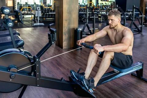 The athlete does exercises on the mushroom simulator in the gym.Sports lifestyle Stock Photos