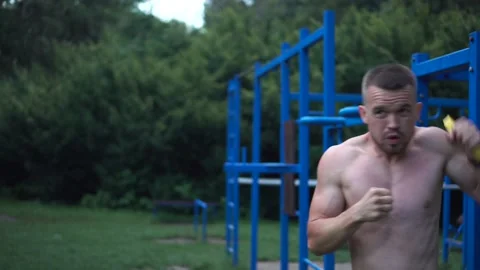 An athlete does resistance group exercises. training outdoors. athletic man Stock Footage 164114237