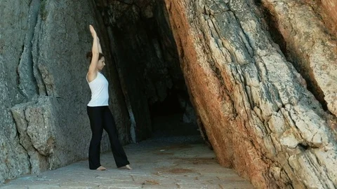 Athlete doing abdominal exercises handstand outdoors throug rocks Stock-Footage 77553508