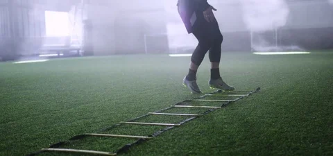 Athlete doing exercise on agility ladder in fitness 動画素材 77330529