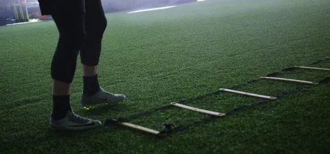 Athlete doing exercise on agility ladder in fitness studio 動画素材 77490207
