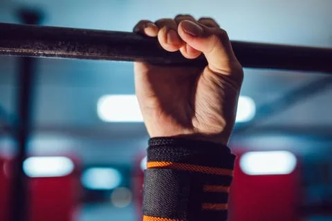 Athlete doing exercise on the horizontal bar Stock Photos