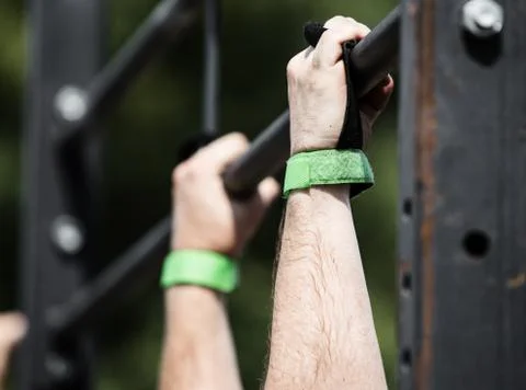 Athlete doing exercise on the horizontal bar, Stock Photos
