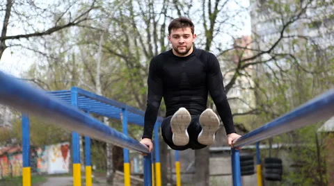 Athlete Doing Exercises on Uneven Bars Stock Footage 62236651