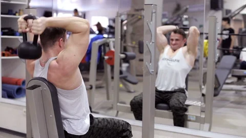 Athlete doing exercises on your triceps with dumbbells Stock Footage 90045926