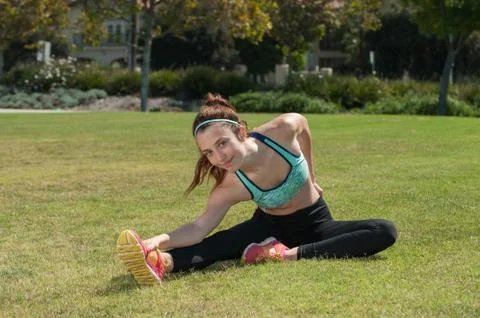 Athlete doing the hurdler's stretch Stock Photos