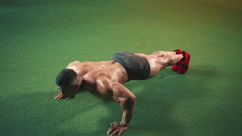 Athlete Doing Intense Push-ups on Artificial Turf Inside the Gym Stock Footage 268831588