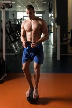 Athlete Doing Kettle Bell Exercise On Medicine Ball Stock Photos