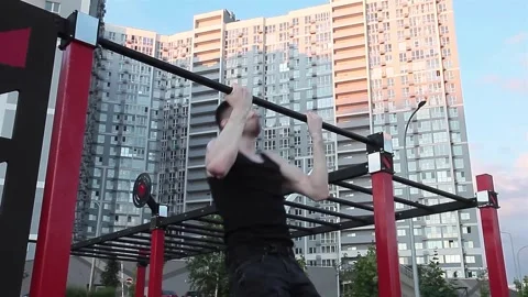 Athlete doing pull-up on horizontal bar. Muscular bearded man doing exercise Stock Footage 245825168