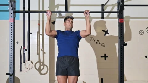 Athlete doing pull-ups at the gym. Handsome man doing functional training. Stock Footage 160442773