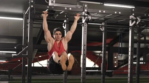 Athlete doing pull-ups at the gym. Handsome man doing functional training. Stock Footage 201405293