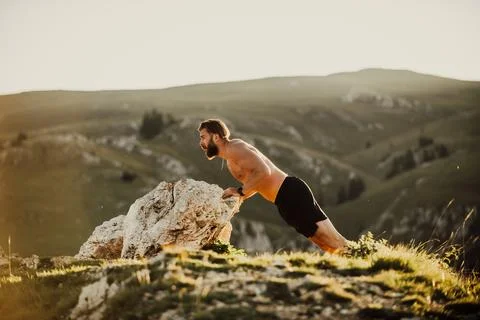Athlete doing push-ups in the early morning. The concept of a healthy life Stock Photos