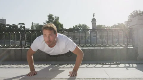 Athlete doing push-ups on run in park - Fitness guy exercising Stock Footage 46417631