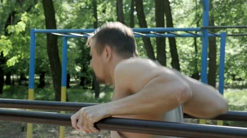 An athlete doing pushups on a bars Stock-Footage 130268670