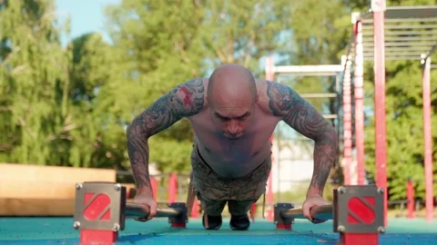 Athlete doing strength exercises on the outdoor playground on a sunny day Stock Footage 201055278
