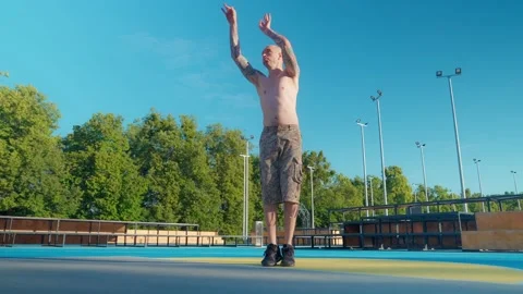 Athlete doing strength exercises on the outdoor playground on a sunny day Stock Footage 201059865