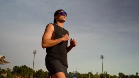 Athlete doing warm-up exercises with hip swivels. He is dressed in black. C.. Stock Footage 267894499
