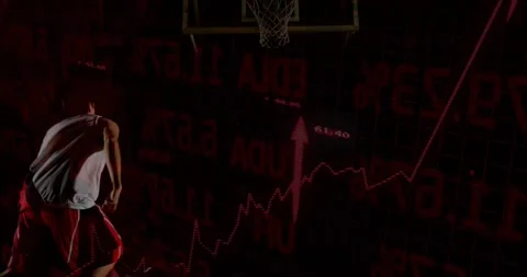 Athlete dribbling forward launching dunk aiming to score while red charts Stock Footage 330540967