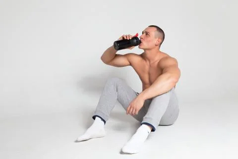 Athlete drinking from a shaker Stock Photos