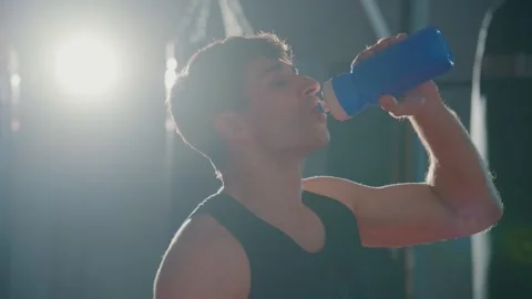 Athlete drinks water after intense training session 스톡 동영상 331341469