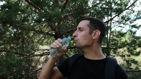 An athlete drinks water from a bottle Stock Footage 246936704