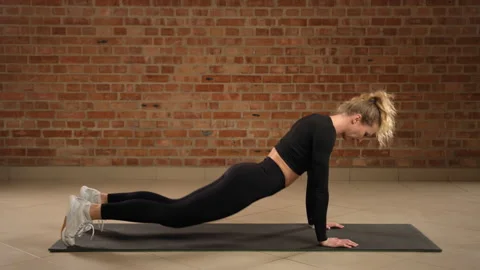Athlete Engaging in Advanced Wave Push-Ups for Enhanced Upper Body Strength and Stock Footage 269196334